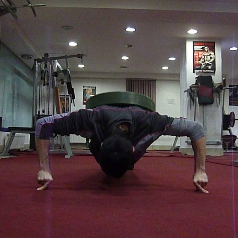 Push-ups on two hands on two fingers and 50 kg on my back.