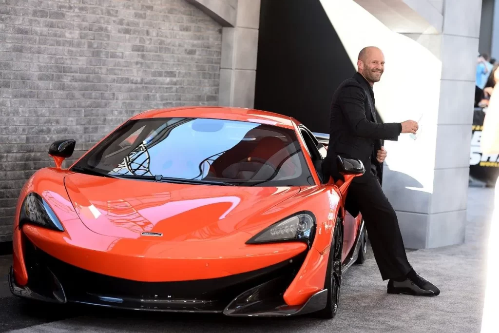 Jason Statham exudes undeniable coolness next to supercars in Fast and Furious.