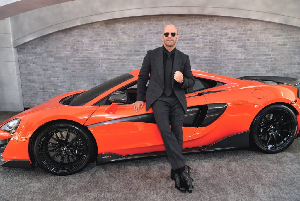 Jason Statham exudes undeniable coolness next to supercars in Fast and Furious.