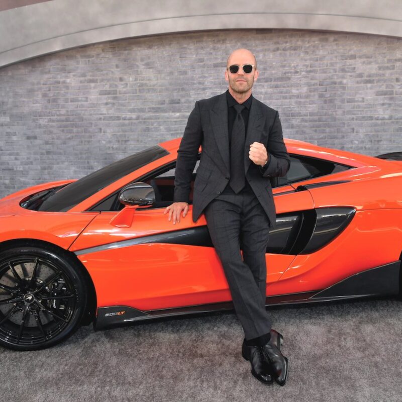 Jason Statham Exudes Undeniable Coolness Next To Supercars In Fast And Furious.